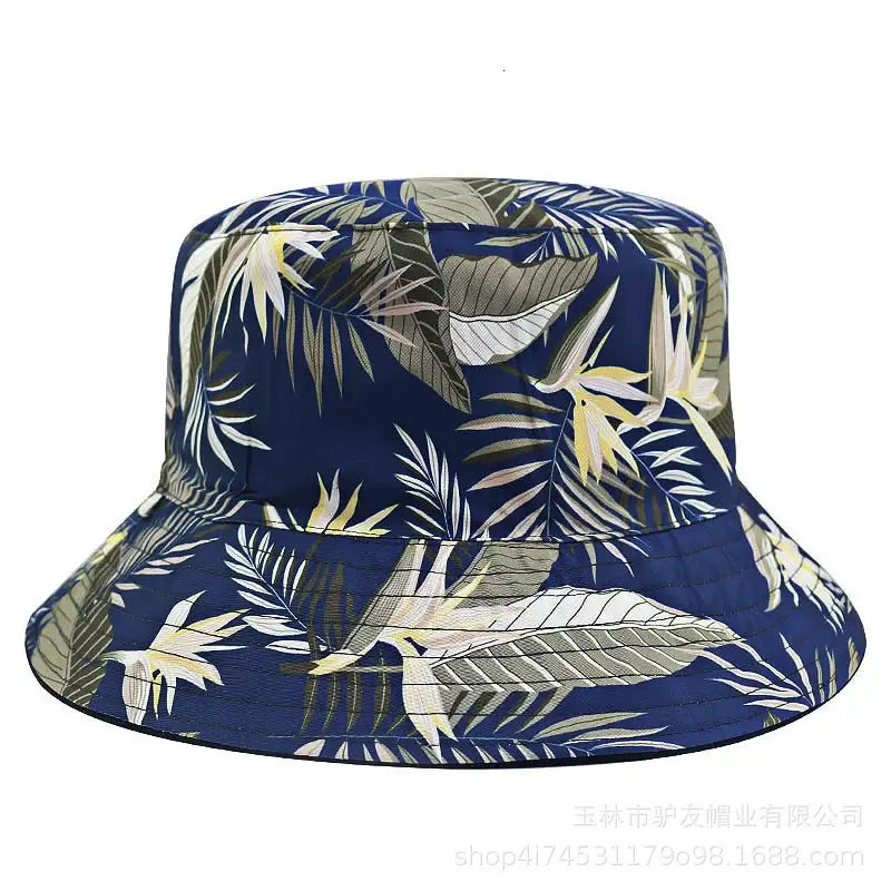 Unisex oversize cotton bucket hat in navy with tropical leaf print. Stylish sun protection perfect for beach outings and casual summer looks.