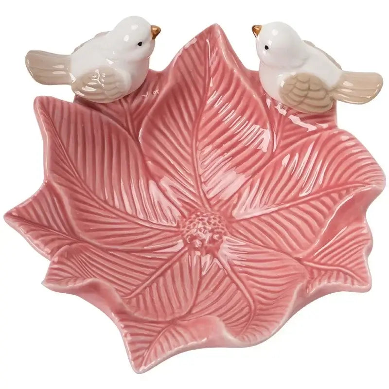 Top view of pink flower-shaped ceramic jewelry tray with two bird figurines, perfect for vanity or dresser organization.