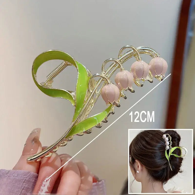 White bell flower ponytail hair clip with green stem, 12cm long, perfect for secure and decorative updos.