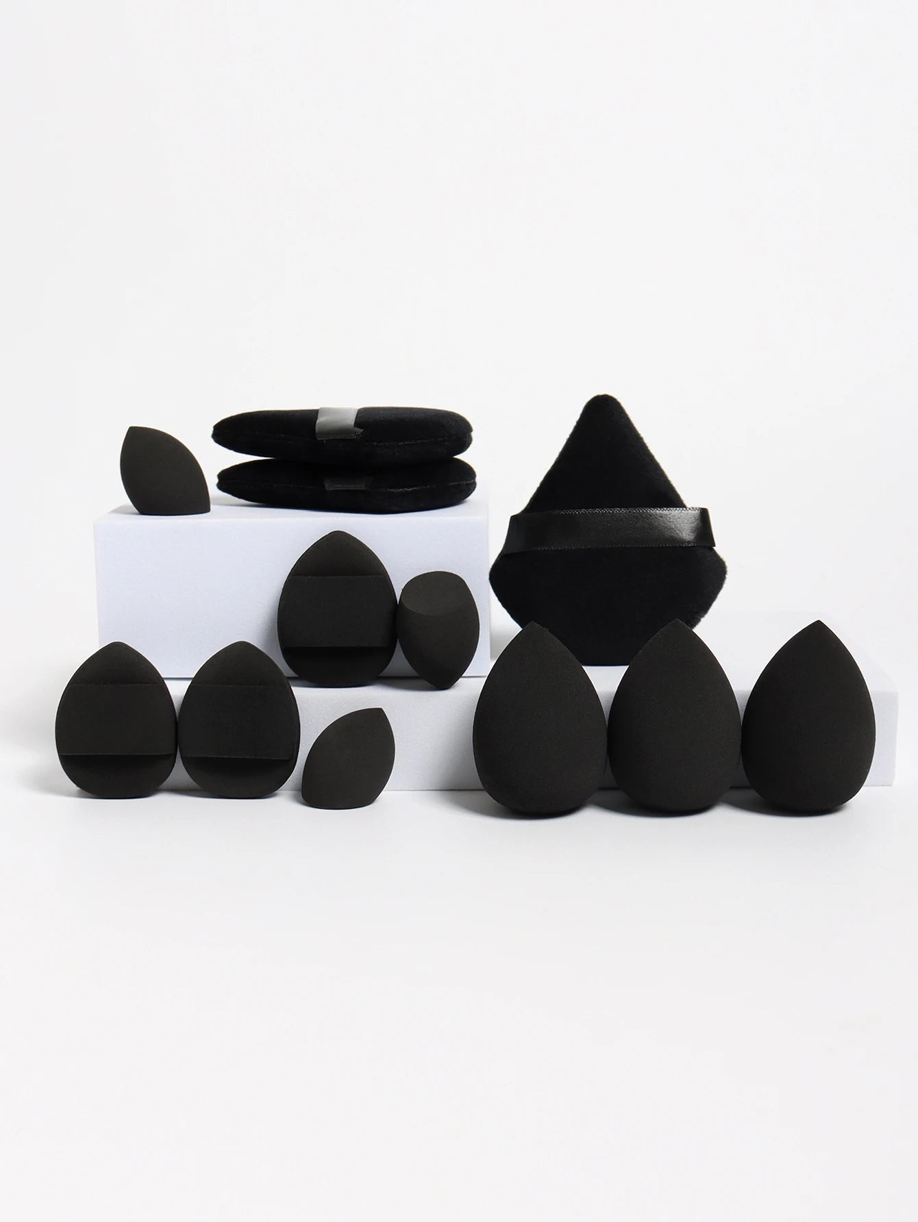 Black 12-piece makeup sponge set with sleek puffs and blending sponges. Offers professional-level precision and coverage.
