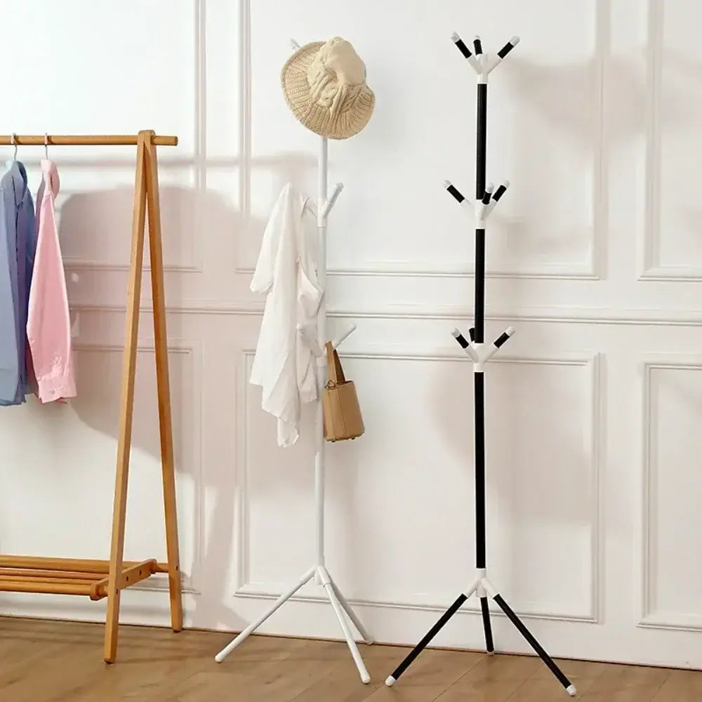 White and black vertical coat racks with tree branch design, each with 9 hooks. Stylish garment racks for modern home organization.