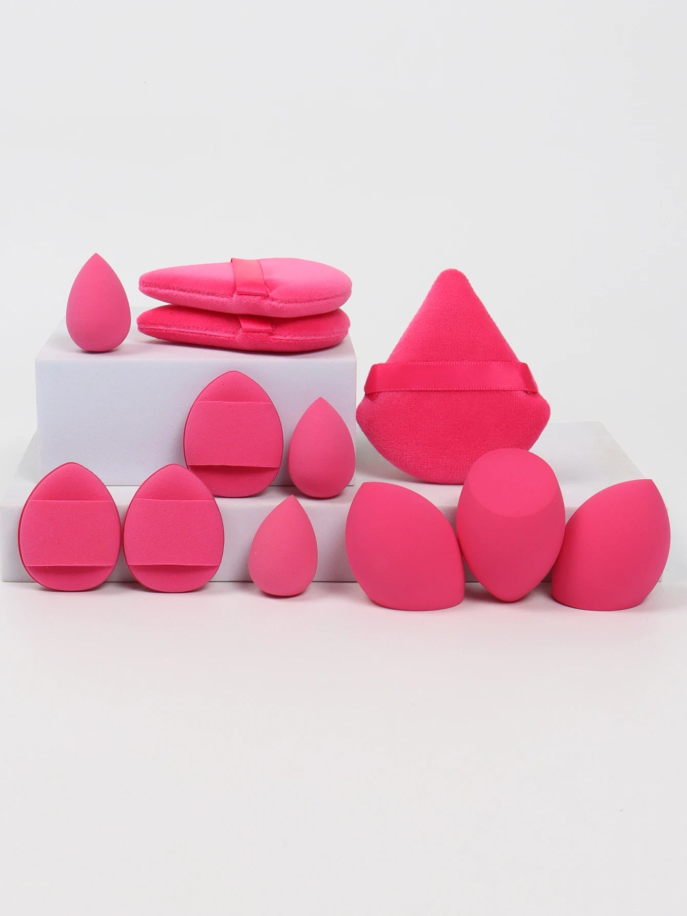 Hot pink 12-piece makeup sponge set with soft puffs and sponges. Perfect for bold makeup looks and even application.