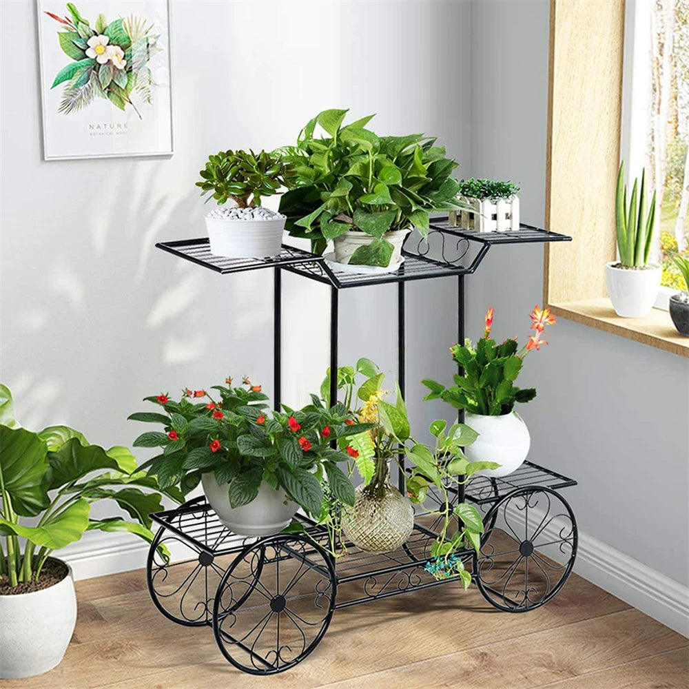 6 Tier Garden Cart Plant Holder with black iron frame displaying potted plants in a bright indoor corner. Ideal for indoor/outdoor plant decor.