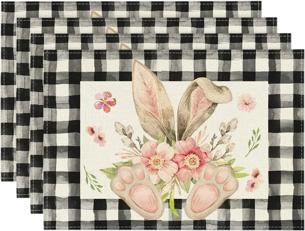 Black checkered Easter placemats with bunny ears, paws, and floral bouquet. Whimsical and durable for festive tables.