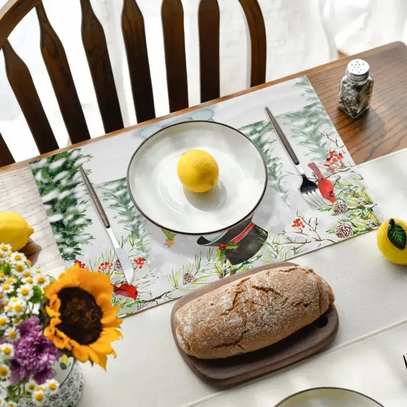 Christmas-themed linen placemat with snowman and forest design, enhancing holiday table settings. Water absorbent and no-crease fabric.