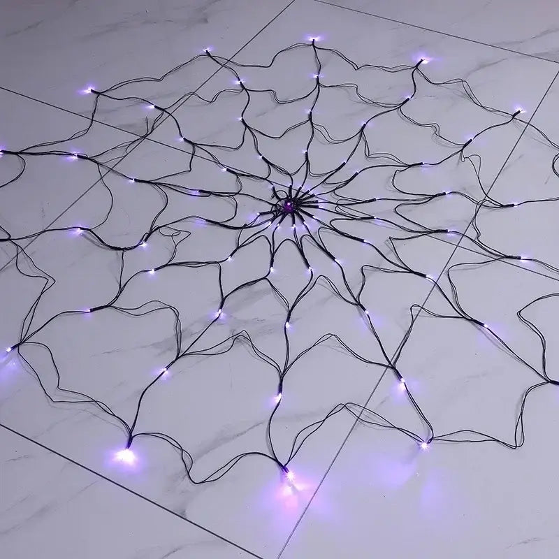 Halloween Ghost LED Light String laid flat on a marble floor, showing purple LED spider web design for versatile decoration.