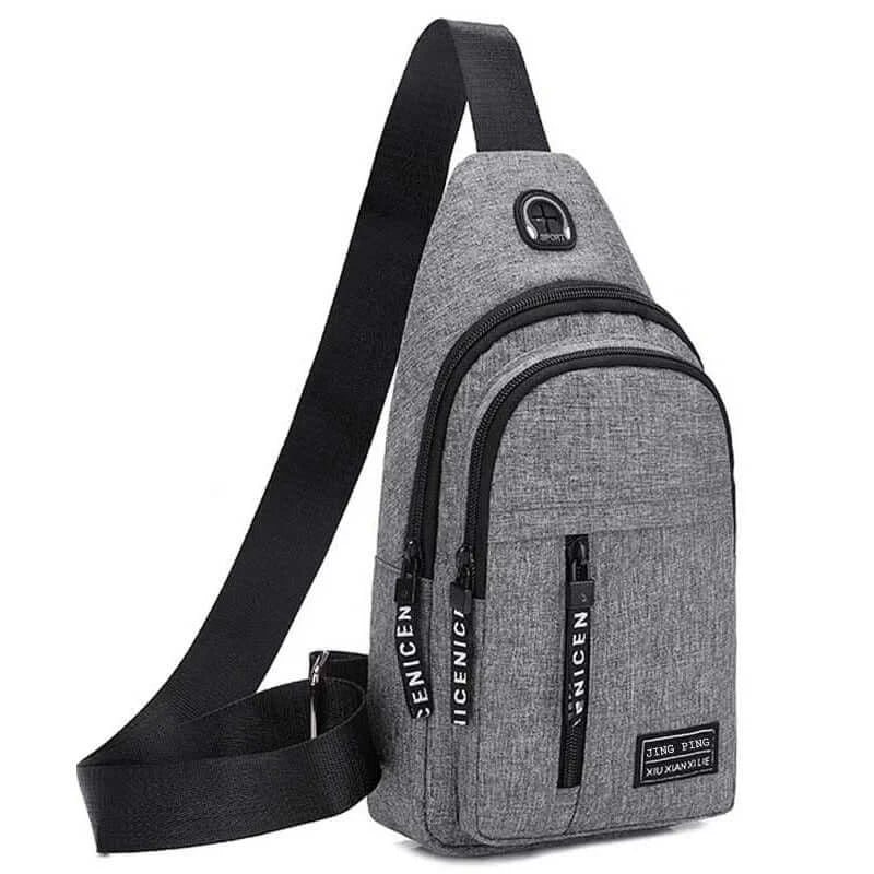 Gray multifunctional crossbody shoulder bag with black zippers and branding, offering a modern look and practical storage.