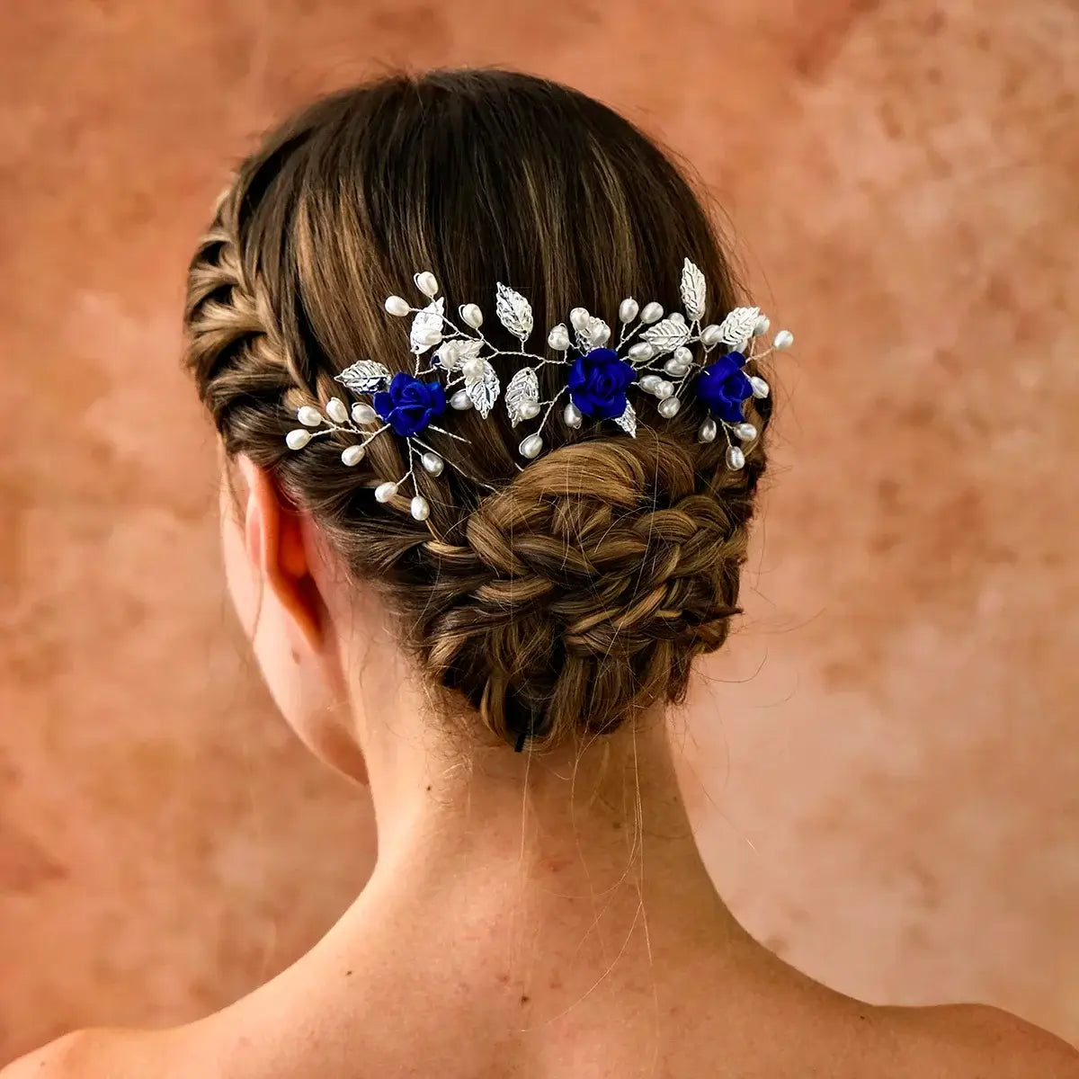 Back view of braided updo adorned with blue 3PK Handmade Flower Hair Pin Set, showcasing elegant floral hair accessories.