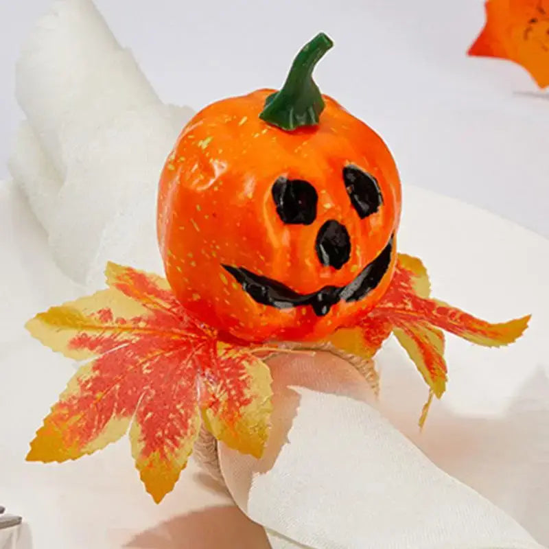 Close-up of a Halloween Pumpkin Napkin Ring featuring a smiling pumpkin and fall leaves, ideal for Halloween table decoration.