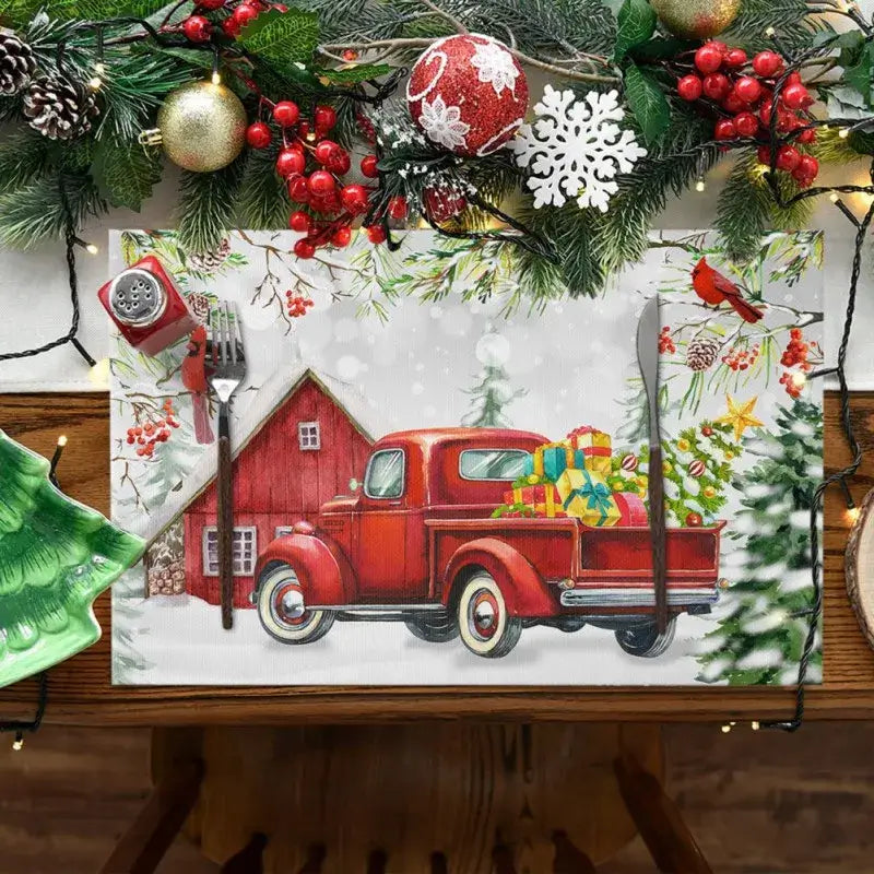 Linen Christmas placemat featuring red vintage truck with gifts and barn, ideal for festive table decor. Water absorbent and wrinkle-resistant.