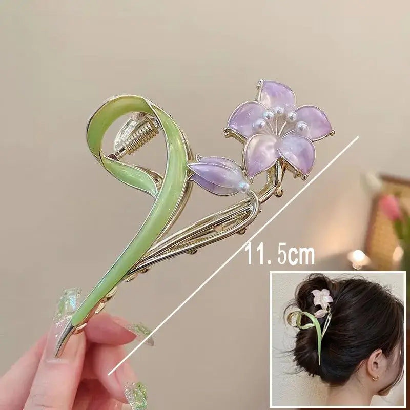 Purple flower ponytail hair clip with pearl accents and green swirl base, 11.5cm long, for stylish and secure hair styling.