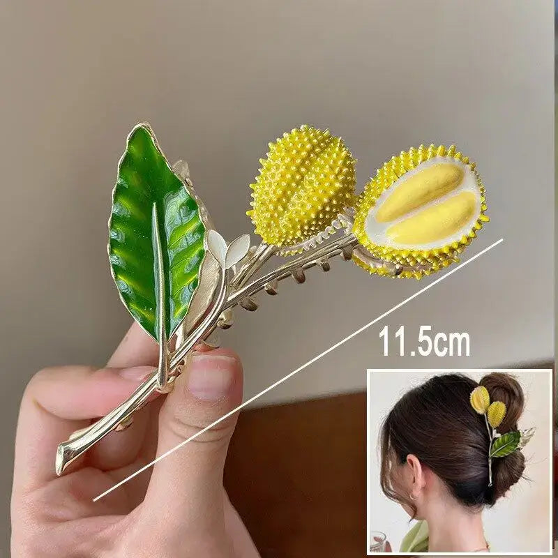 Yellow spiky flower ponytail hair clip with green leaf, 11.5cm long, offering a secure and stylish hold for all hair types.