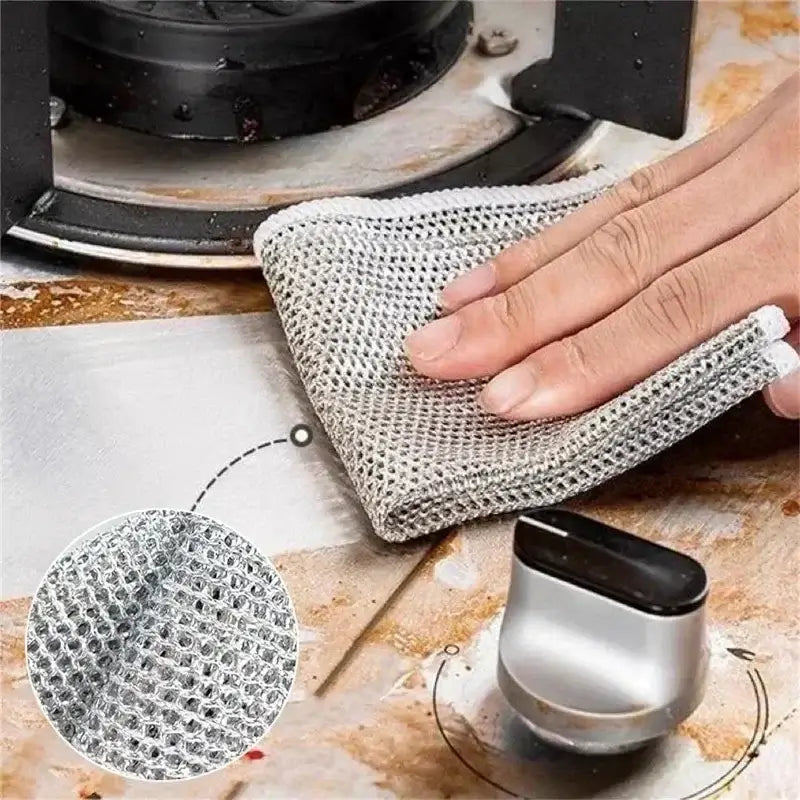 Magic Dishcloth Silver Wire scrubbing greasy stovetop, demonstrating powerful grease removal without scratching surfaces.