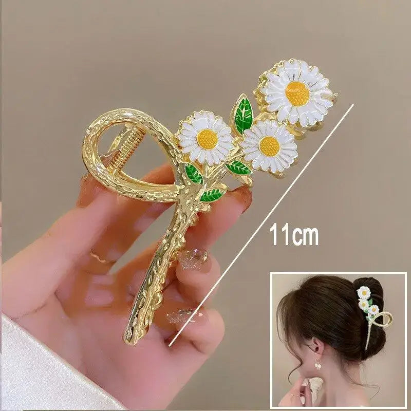White daisy ponytail hair clip with gold loop design, 11cm in size, perfect for stylish and secure ponytails or buns.