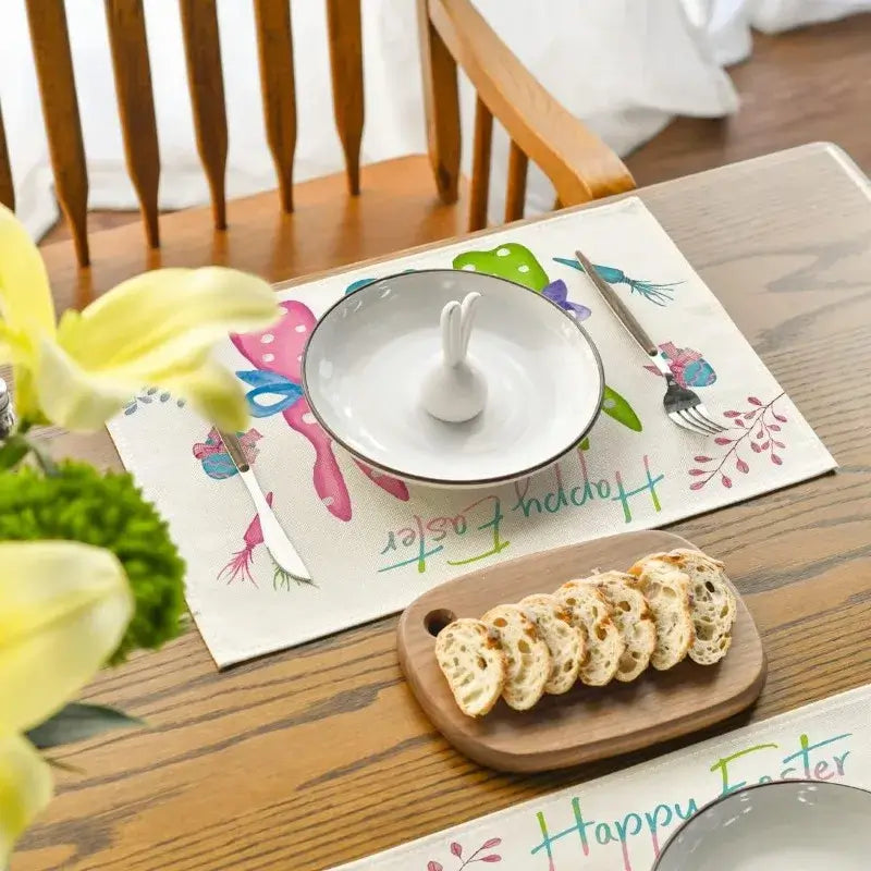 Festive Easter placemat with bunny silhouettes and spring elements, set on a dining table with bread and floral centerpiece.