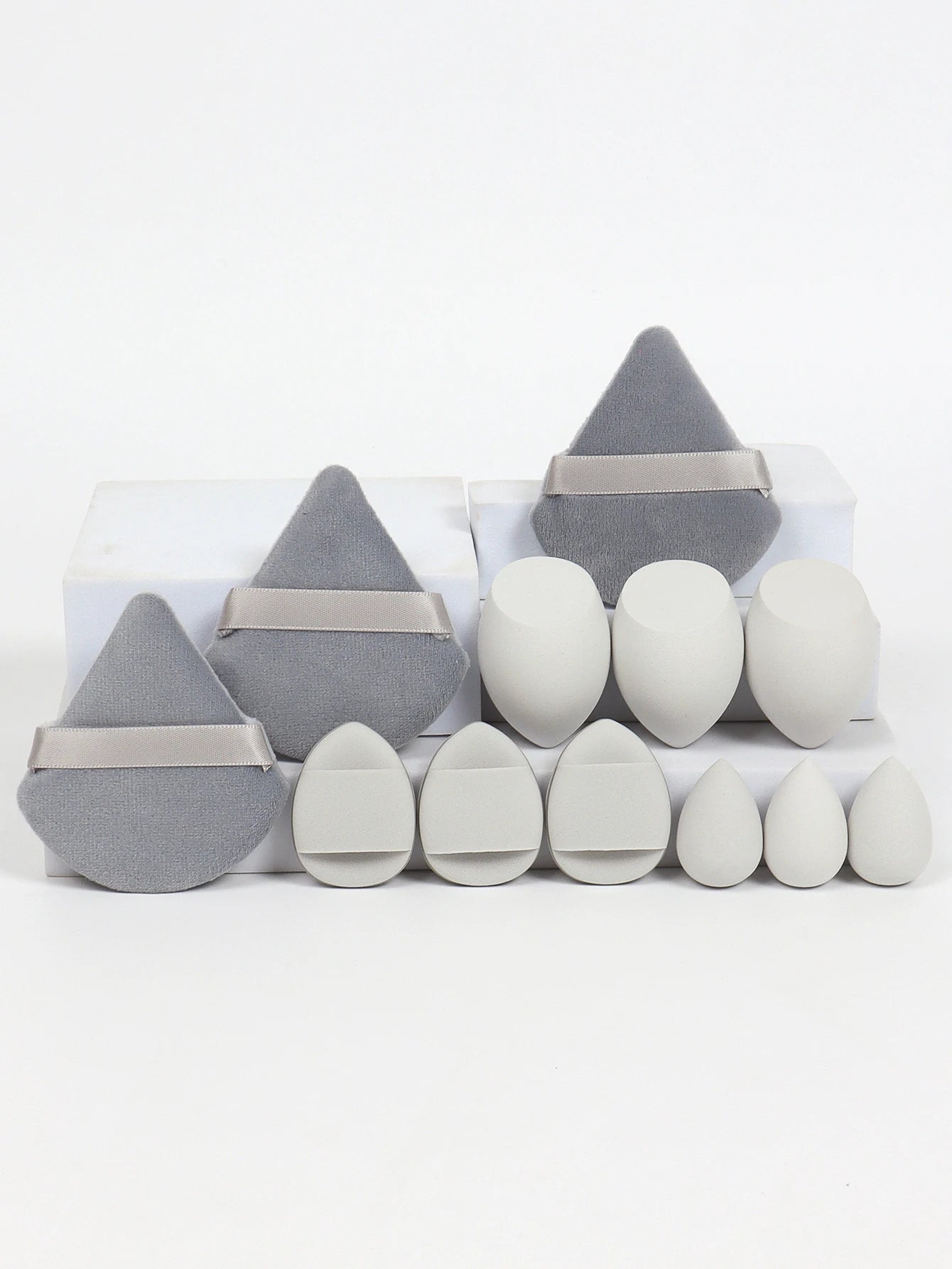 Gray and white 12-piece makeup sponge set with soft puffs and teardrop sponges. Perfect for smooth, even makeup application.