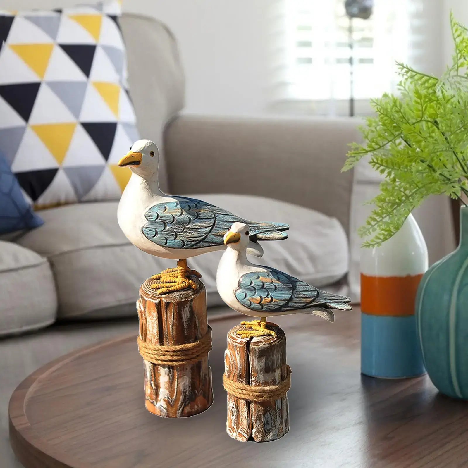 2pcs wooden seagull figurine set on a coffee table, enhancing coastal home decor with rustic nautical garden sculpture appeal.