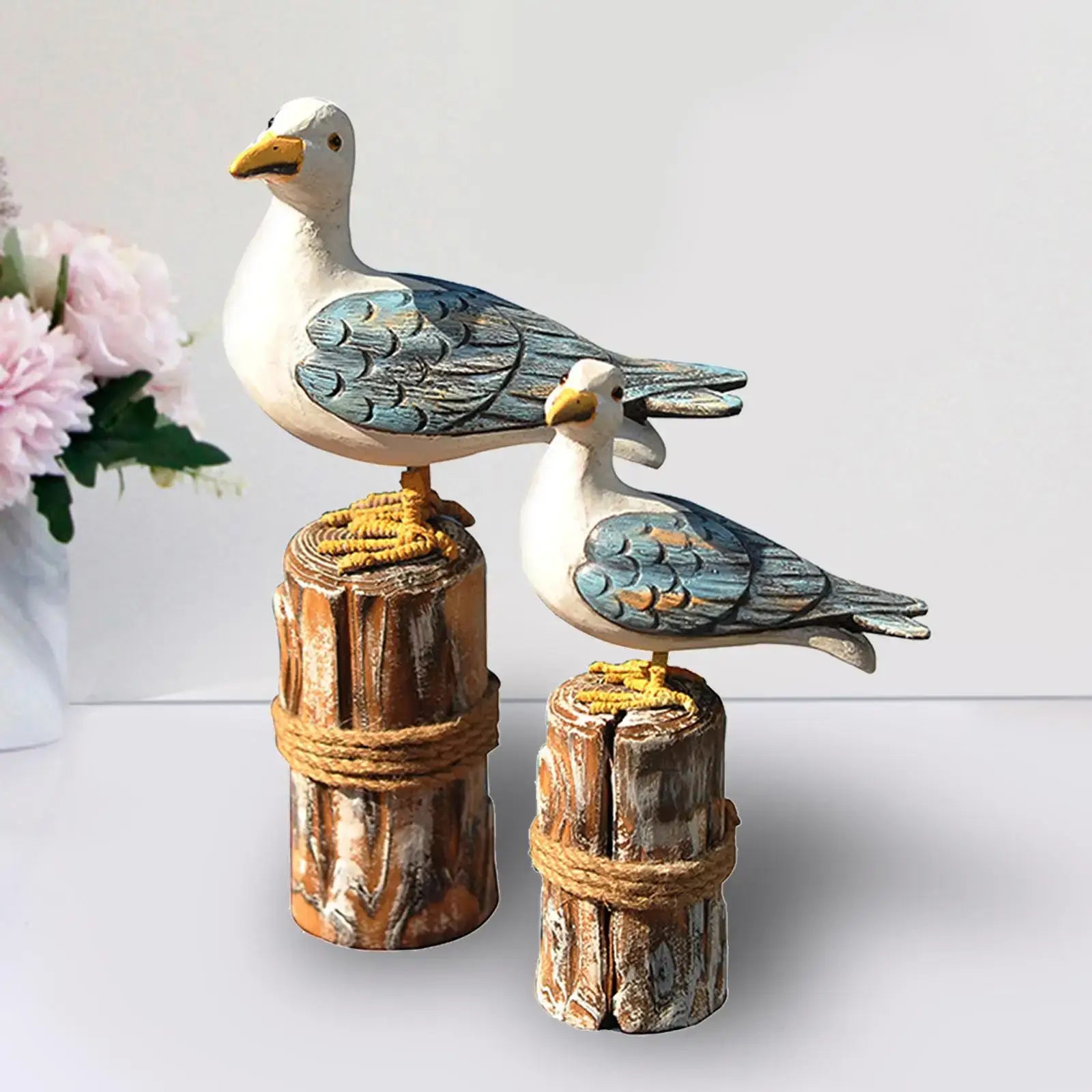 Charming 2pcs wooden seagull figurine set with weathered wood finish, ideal for nautical garden sculptures or rustic home decor.