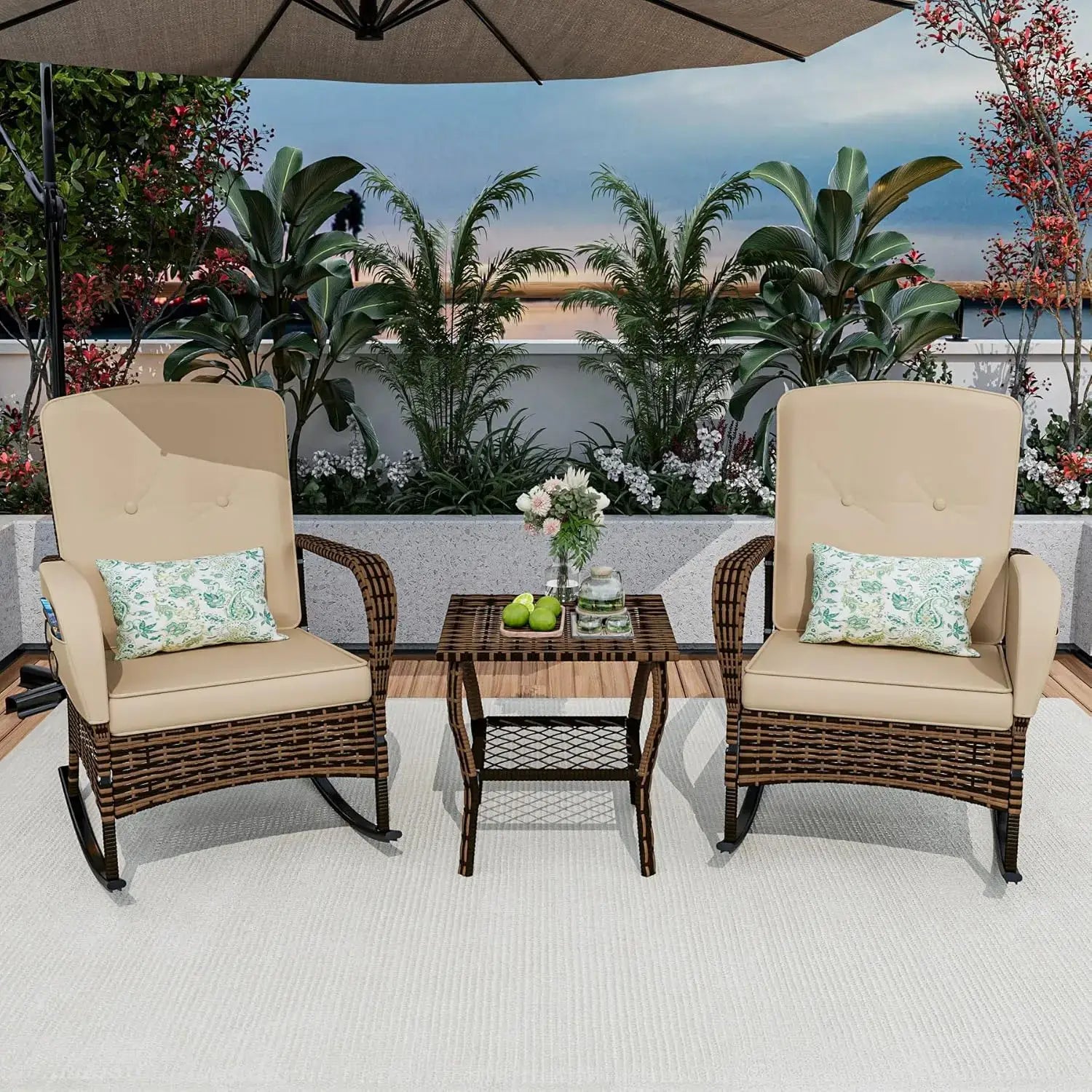 3-piece patio rocking chair set with beige cushions and rattan frame, arranged on a rooftop deck with tropical plants.