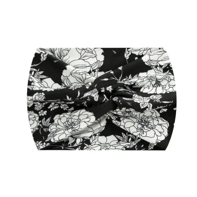 Black floral 18CM stretch printed headband with white flowers. Ideal for workouts or everyday fashion.