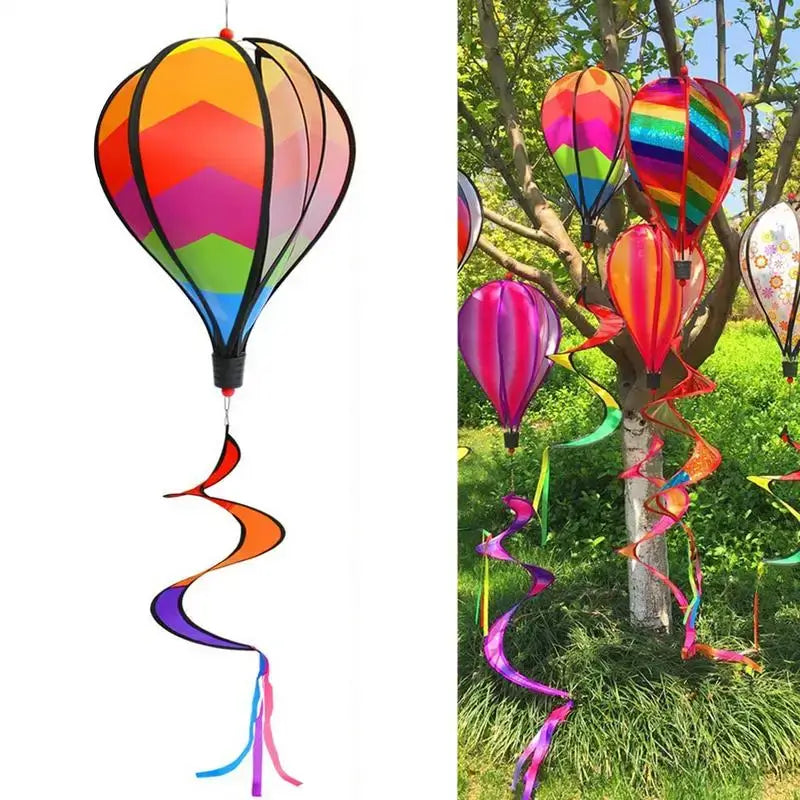 Hot Air Balloon Wind Spinner in vibrant rainbow colors hanging from a tree, ideal for garden decor and outdoor parties. Easy to install and eye-catching.