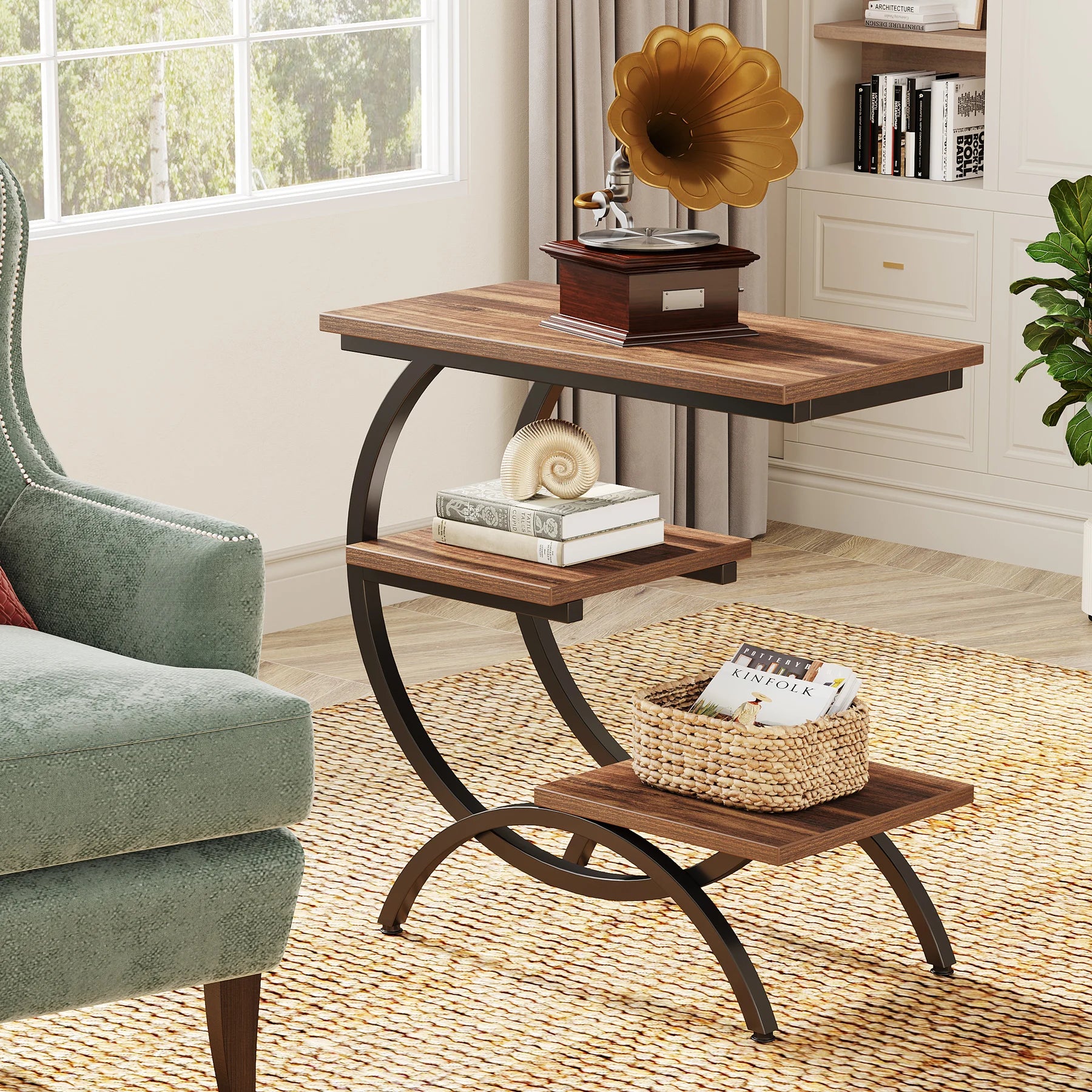Rustic 3-tier side table with curved black frame, used as an accent piece near a green armchair and window.