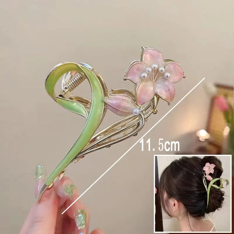 Pink flower ponytail hair clip with pearl center and green swirl base, 11.5cm long, for stylish and secure hairdos.