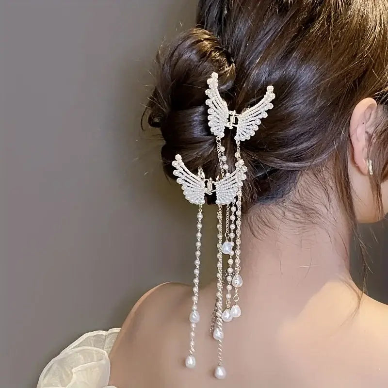 Double Women Butterfly Tassel Hair Clips styled on a bun. Lightweight butterfly clips with pearl tassels add charm to formal hairstyles.