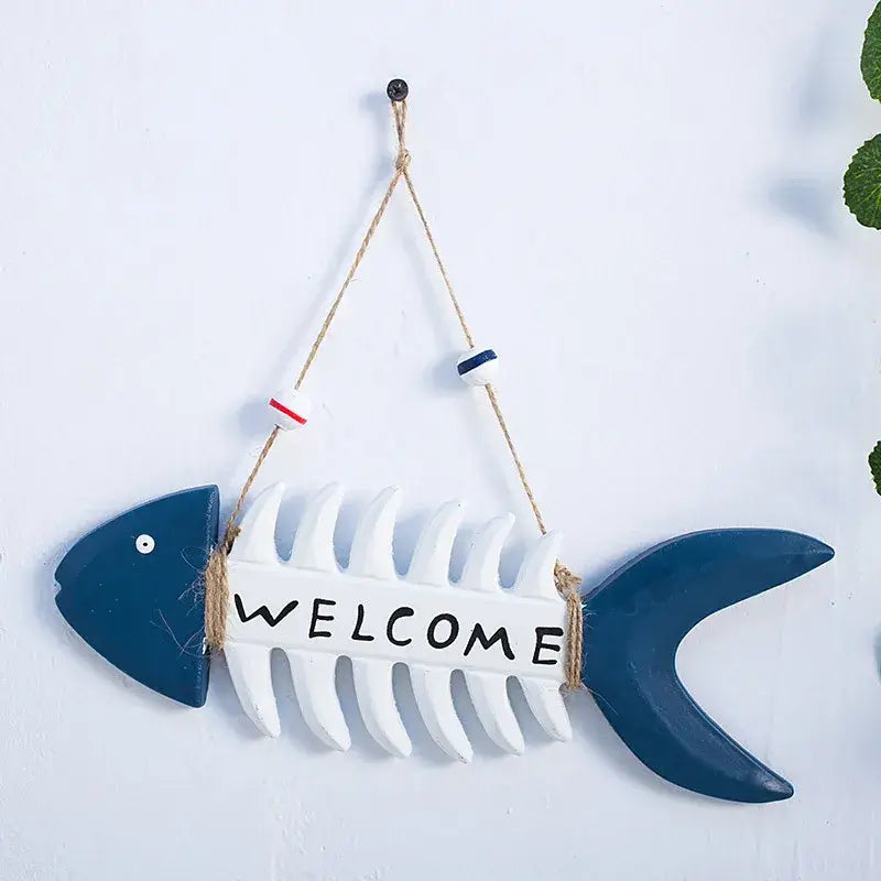 Mediterranean Welcome Sign shaped like a fish skeleton with blue head and tail, ideal for beach-themed outdoor or indoor decor.