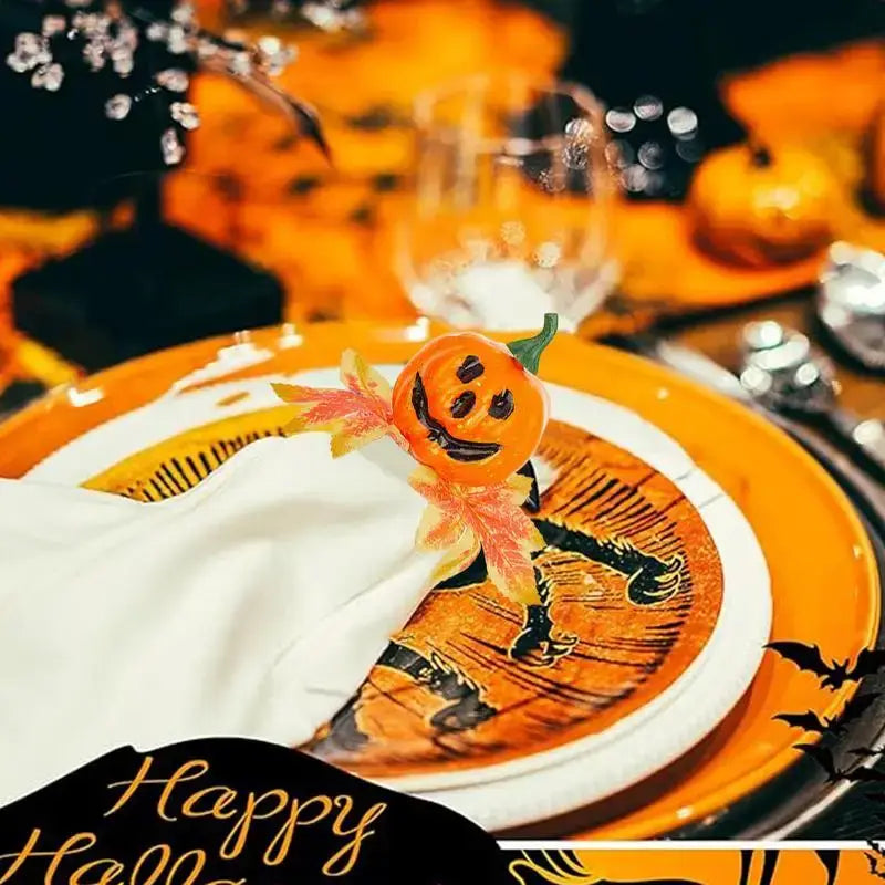Halloween-themed table setting featuring a pumpkin napkin ring from the 6-piece Halloween Pumpkin Napkin Rings Set on a festive orange plate.
