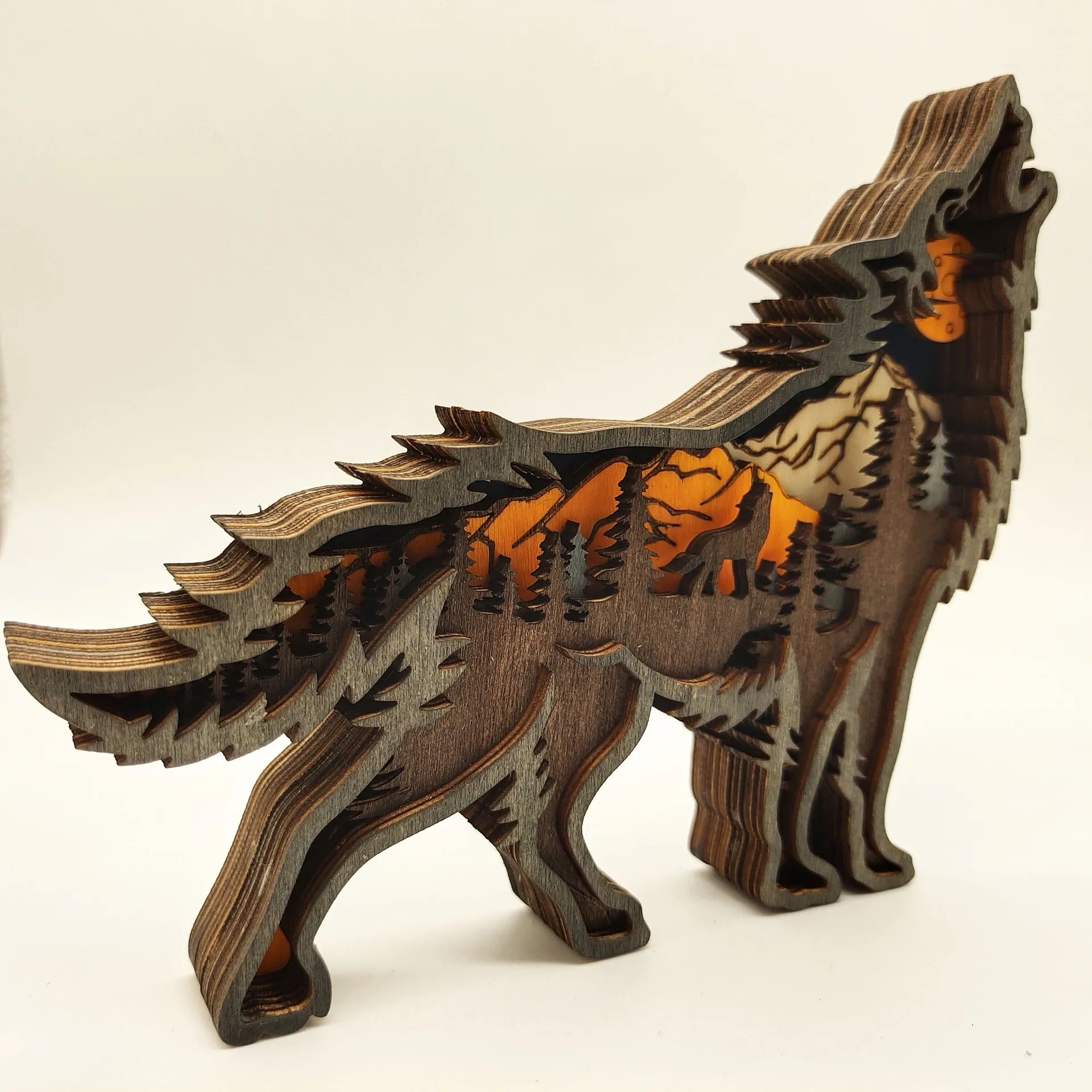 Wooden wolf figurine with howling pose and forest scene, carved wooden art for rustic home décor and nature-themed accents.