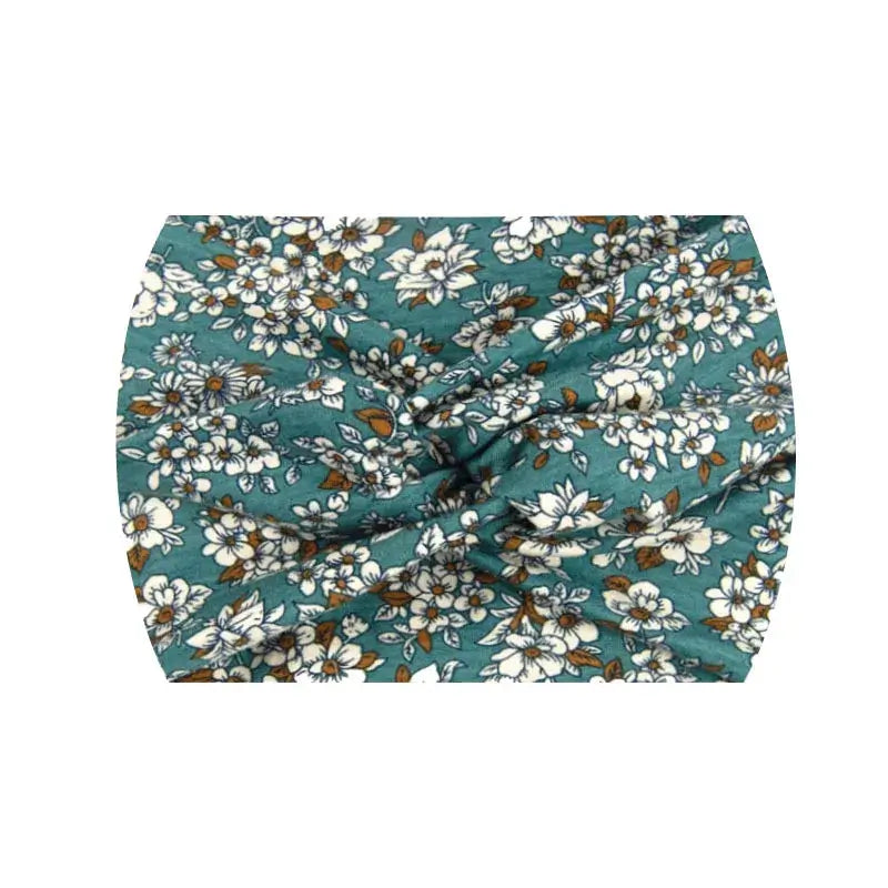 Teal floral 18CM stretch printed headband with white blossoms. Breathable and perfect for sports or fashion use.