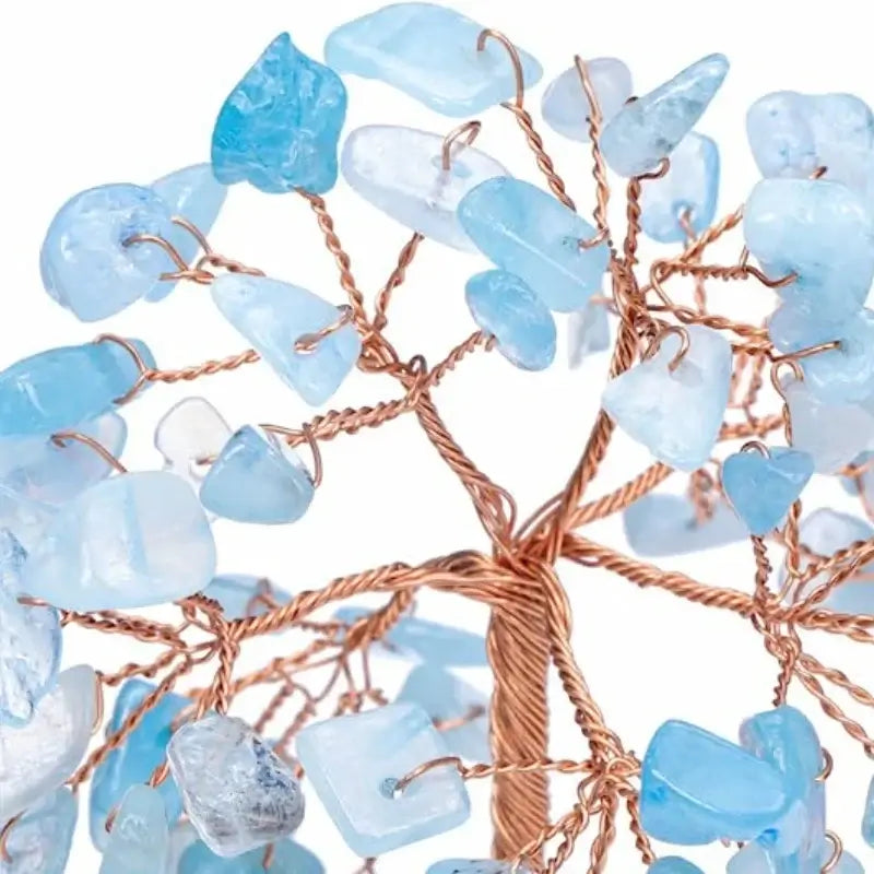Close-up of aquamarine crystal chips on a copper wire money tree. Enhances tranquility and beauty in home or office decor.
