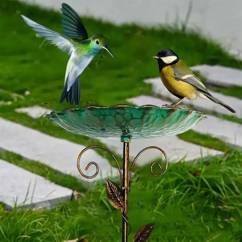 Metal Bird Bath Feeder with leaf design in use, showing birds perched on the green bowl in a garden setting.
