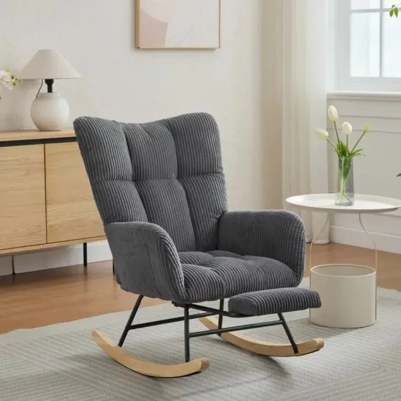 Modern rocking glider chair with high backrest in gray corduroy fabric, solid wood legs, and ergonomic design for nursery or living room use.