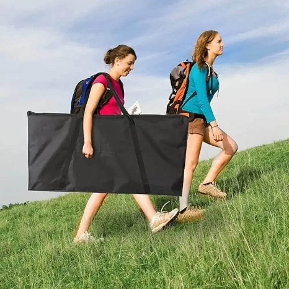 Two women carrying the portable Wood Cornhole Boards Set in a black carry case while hiking outdoors. Lightweight and travel-friendly.